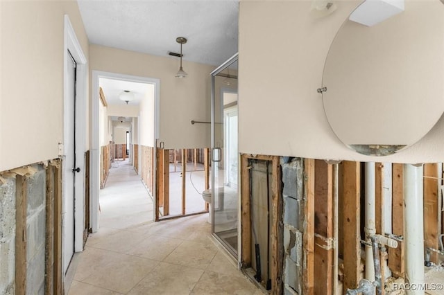 hall with light tile patterned floors