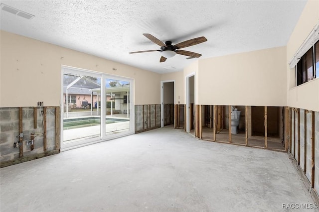 spare room with ceiling fan, concrete flooring, and a textured ceiling