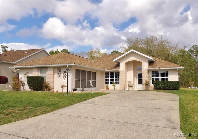 ranch-style home with stucco siding and a front lawn