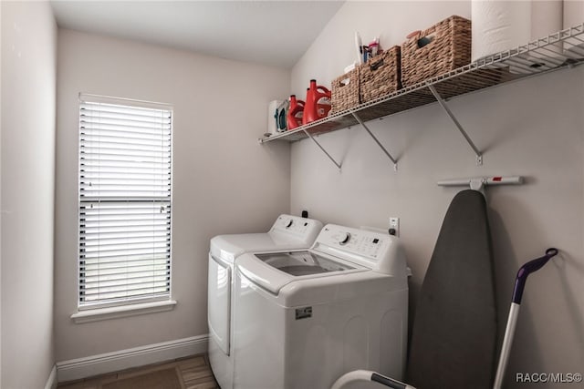 laundry room featuring washer and clothes dryer and baseboards
