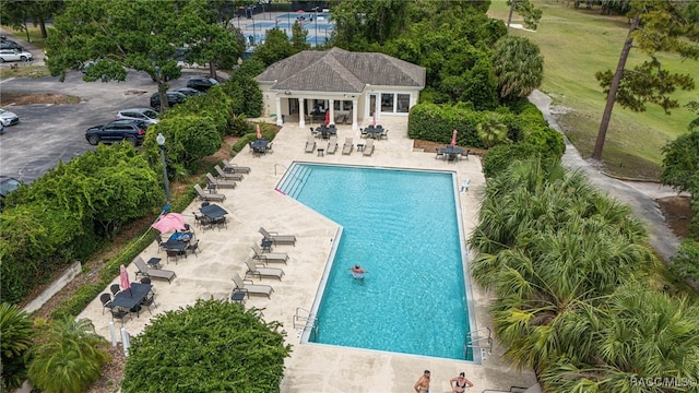 community pool featuring a patio and an outdoor structure