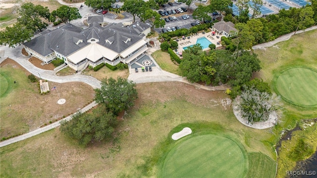 aerial overview of property's location with a local golf course and a pool