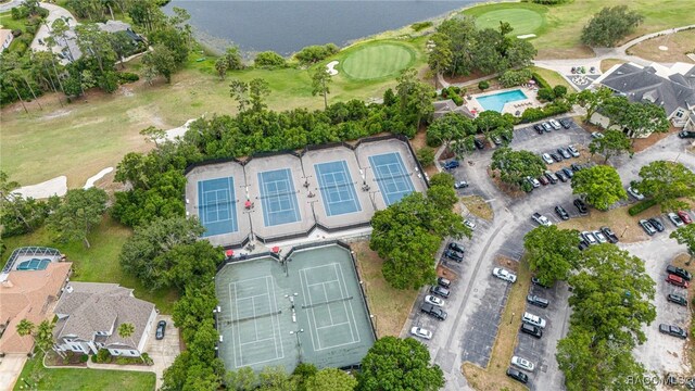 view of property location featuring a golf course and a pool area