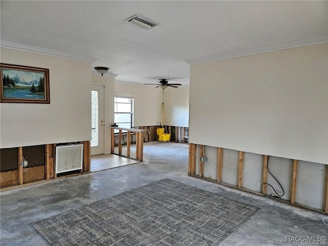 empty room with unfinished concrete floors, visible vents, and crown molding