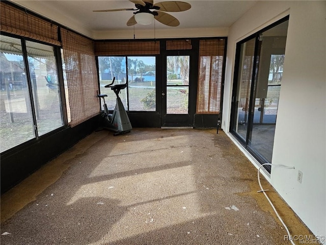 unfurnished sunroom with plenty of natural light and ceiling fan