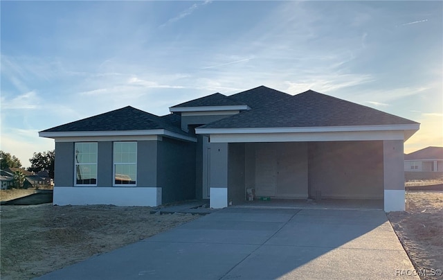 view of front of property featuring a carport