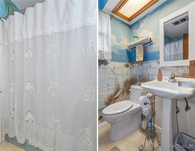 full bathroom featuring tile patterned flooring and toilet