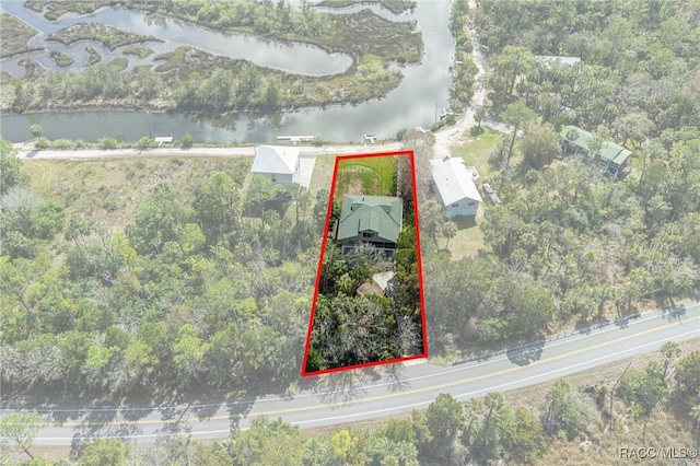 birds eye view of property with a water view