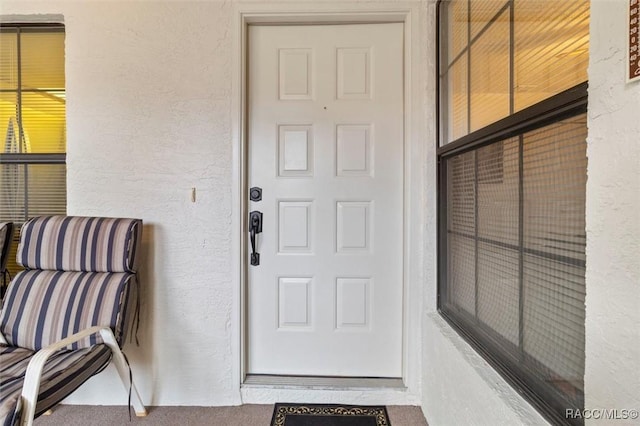 entrance to property with stucco siding