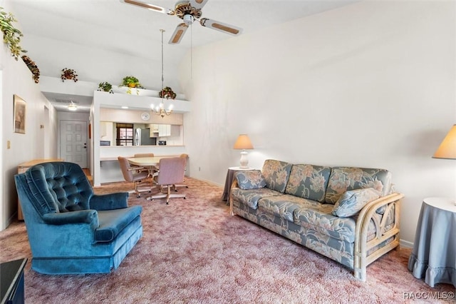 living room featuring carpet floors, high vaulted ceiling, baseboards, and ceiling fan with notable chandelier