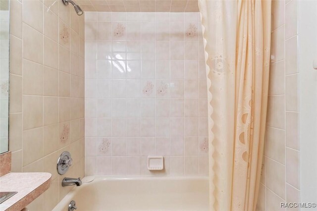 full bathroom featuring shower / bath combination with curtain