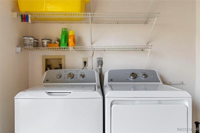 laundry room with laundry area and washer and clothes dryer