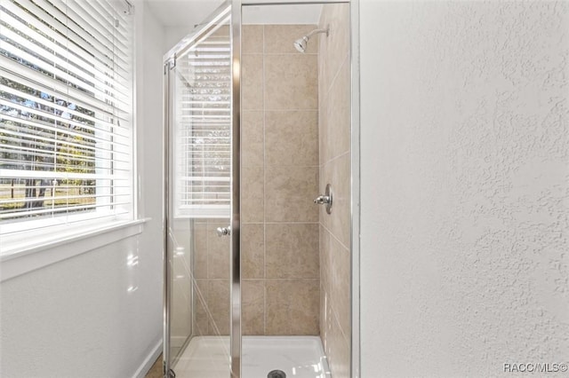 bathroom with a shower with shower door