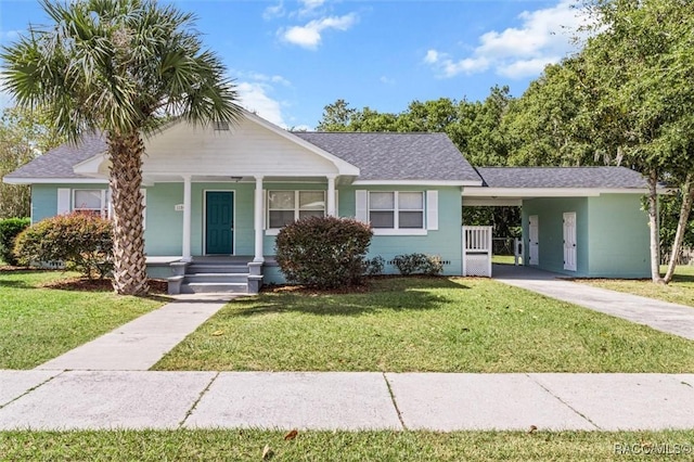 ranch-style home featuring a carport and a front lawn