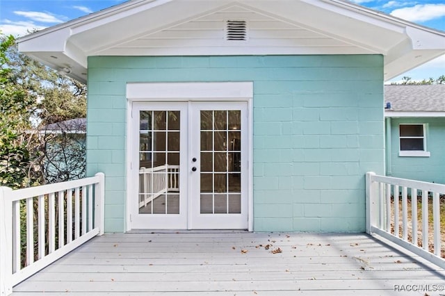 property entrance with a wooden deck and french doors