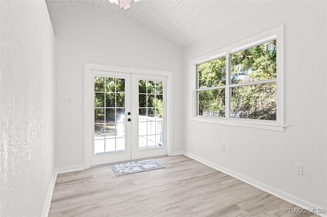 doorway to outside featuring lofted ceiling, french doors, and light wood-type flooring