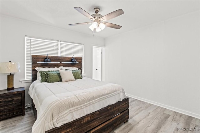 bedroom with ceiling fan and light hardwood / wood-style flooring