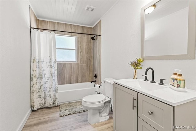 full bathroom with hardwood / wood-style floors, vanity, toilet, crown molding, and shower / bath combo with shower curtain