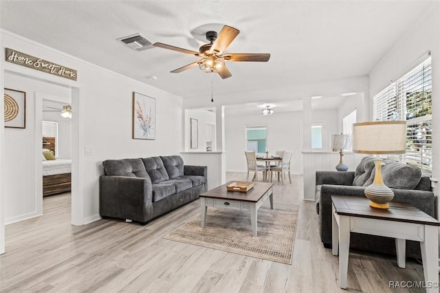 living room with ceiling fan and light hardwood / wood-style flooring