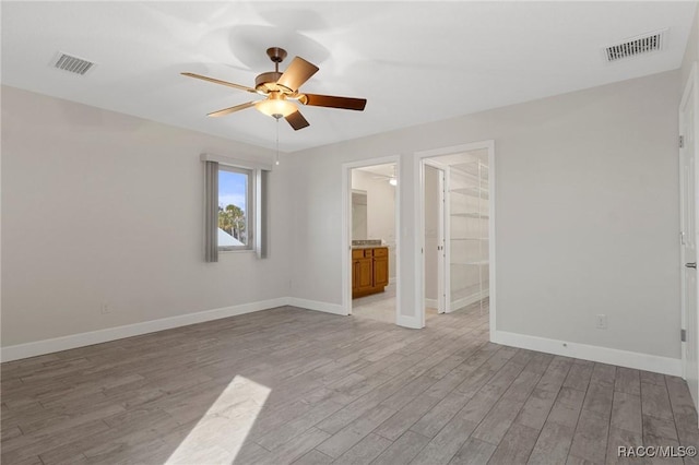 empty room featuring ceiling fan and light wood-type flooring