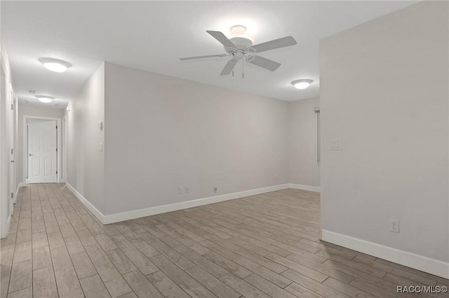 empty room with ceiling fan and light wood-type flooring