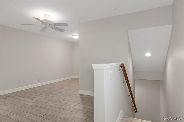 empty room featuring ceiling fan and light hardwood / wood-style floors