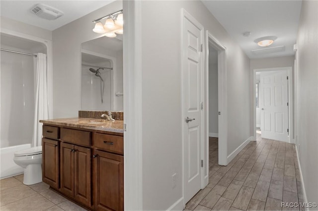 full bathroom featuring vanity, wood-type flooring, toilet, and shower / tub combo with curtain