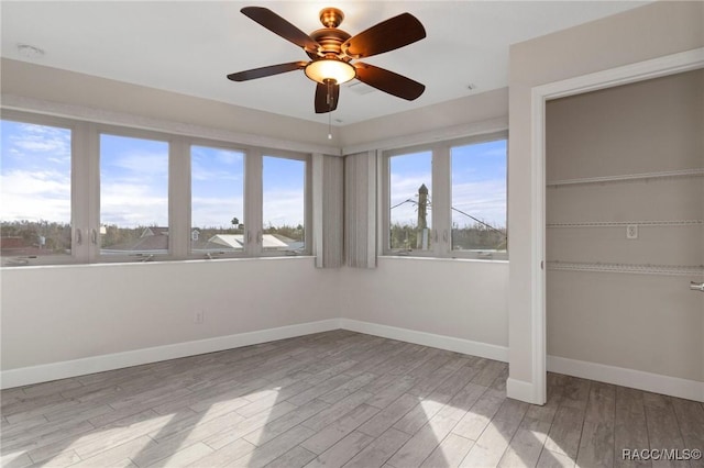 unfurnished bedroom featuring multiple windows, a closet, and light wood-type flooring