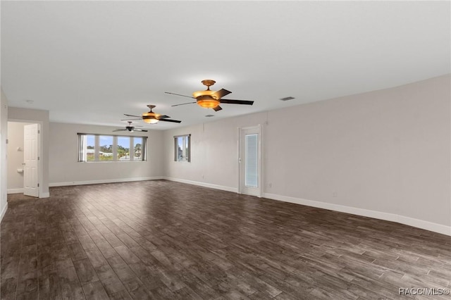 empty room with dark hardwood / wood-style floors and ceiling fan