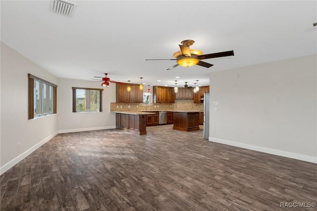 unfurnished living room featuring dark wood-type flooring and ceiling fan