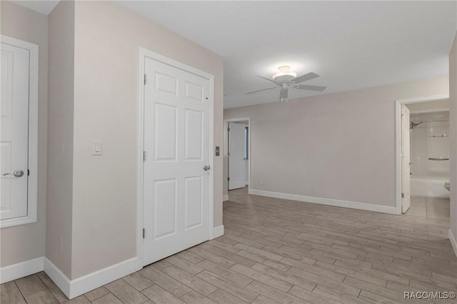 empty room with ceiling fan and light wood-type flooring