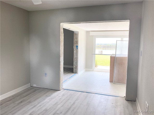 unfurnished room with light wood-type flooring