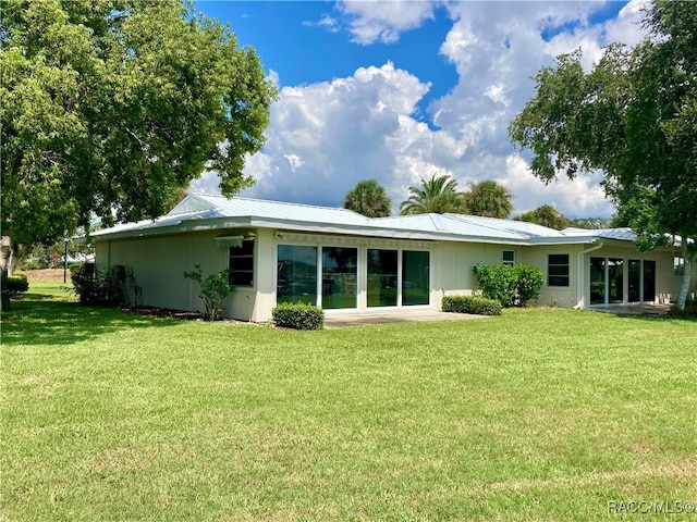 back of house with a lawn