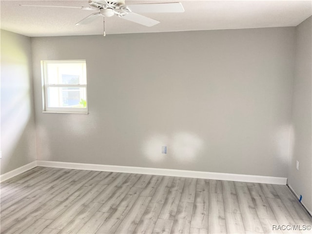 unfurnished room featuring ceiling fan and light wood-type flooring