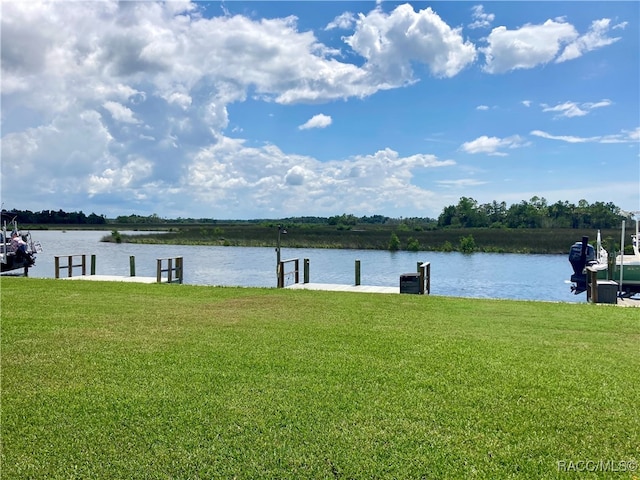 view of dock featuring a yard and a water view