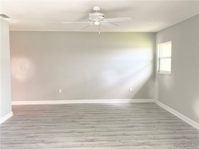 spare room featuring ceiling fan and light hardwood / wood-style floors