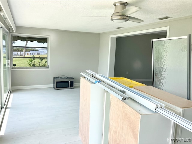 interior space with a textured ceiling and light wood-type flooring