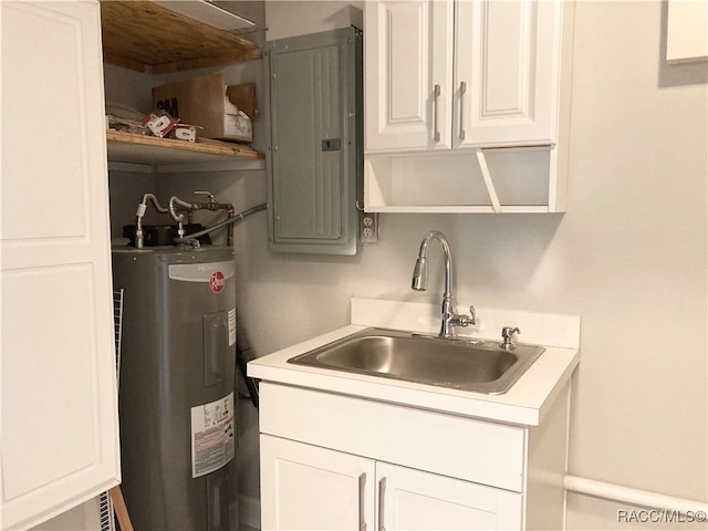 kitchen with white cabinets, electric water heater, sink, and electric panel