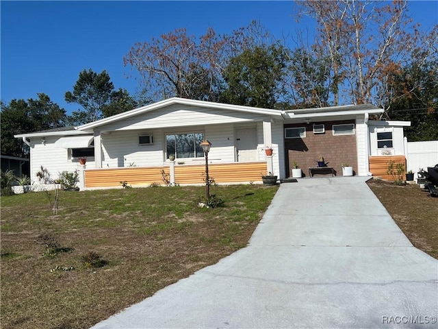 ranch-style house featuring a carport and a front lawn