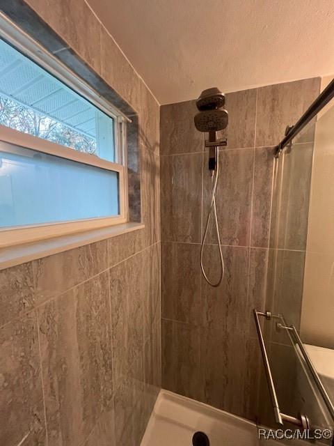 bathroom with a tile shower