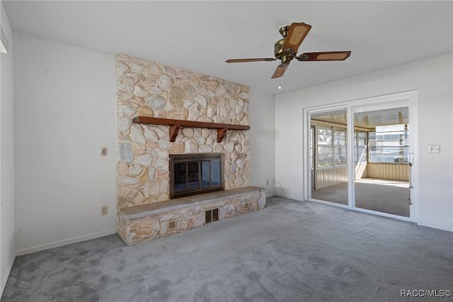 unfurnished living room with ceiling fan, carpet floors, and a fireplace