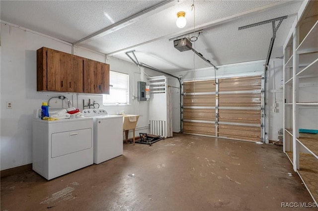 garage featuring independent washer and dryer, electric panel, sink, and a garage door opener