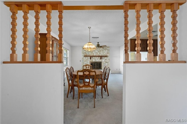 carpeted dining area with a fireplace