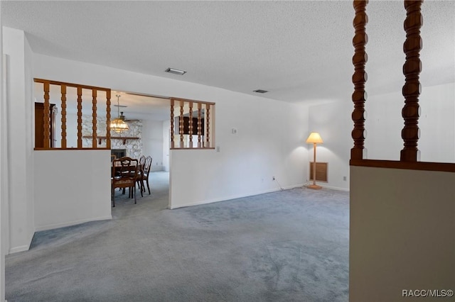 carpeted spare room with a textured ceiling