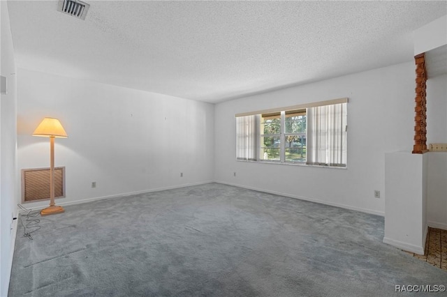 unfurnished room with a textured ceiling and carpet