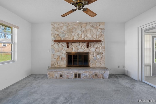 unfurnished living room featuring ceiling fan, carpet flooring, and a fireplace