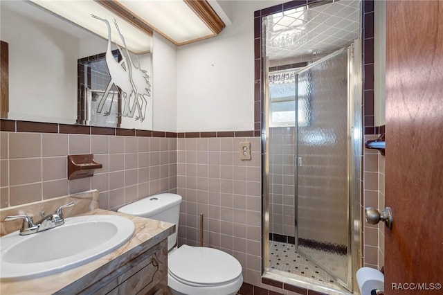 bathroom featuring toilet, tile walls, walk in shower, and vanity