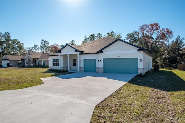 view of front of home featuring central air condition unit, a garage, stone siding, driveway, and a front yard