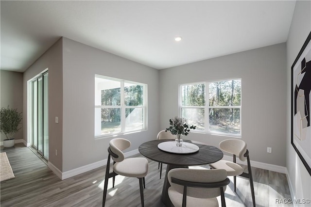 dining area featuring recessed lighting, wood finished floors, and baseboards