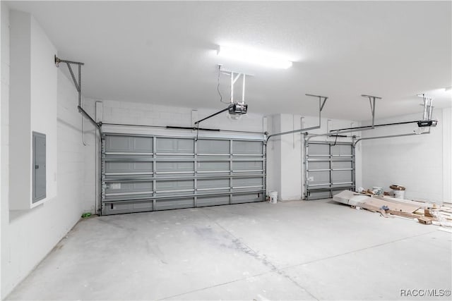 garage with electric panel and a garage door opener